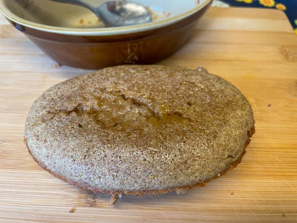 Baked wheatmeal pudding baked and removed from oven dish.