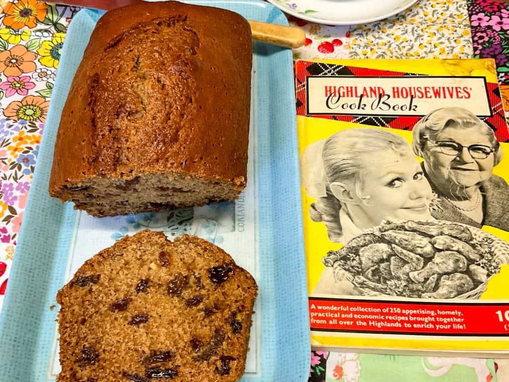 Jocks loaf sliced on blue tray with Highland Wives cook book to side.