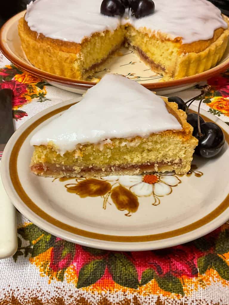 Slice of Bakewell tart on serving plate.