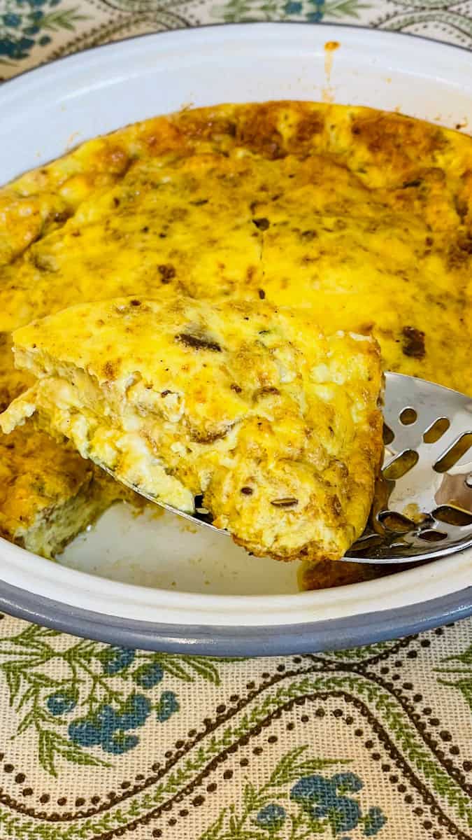 A slice removed from cheese pudding and shown close to the front of the photo.